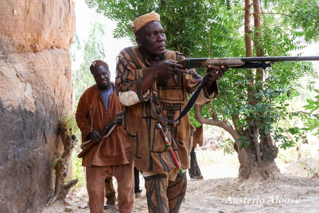 dozo hunters with their rifles in the forest
